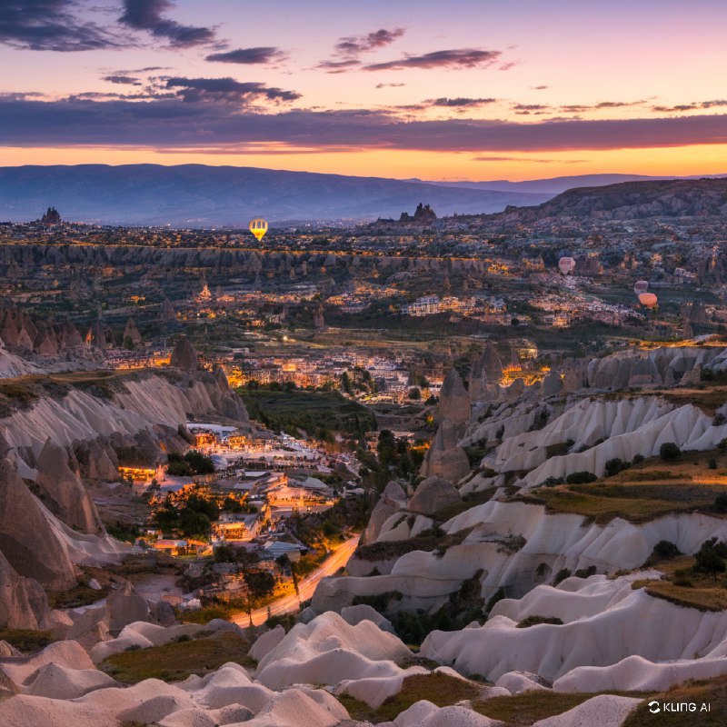 #Bing_Wallpaper"卡帕多西亚格雷梅国家公园在日落时分的迷人鸟瞰图，展现出独特的岩石地貌和阳光洒满山谷的宁静景色，被金色与紫色的光辉所沐浴